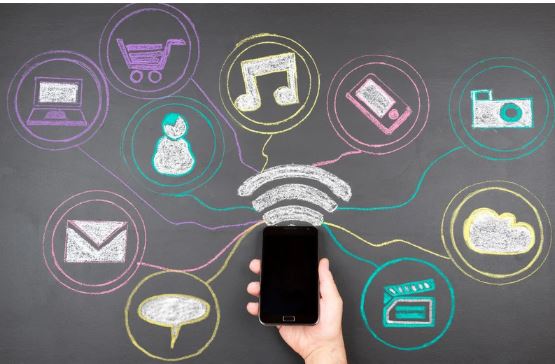 A smartphone connected to multiple social media and digital platforms, representing constant online engagement and data-driven digital behaviour