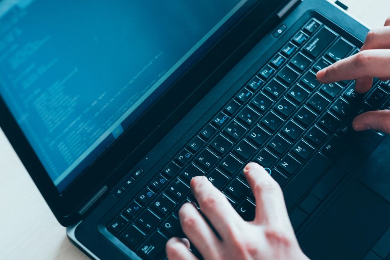 Child learning to code on a laptop, representing AI and digital skills education at Asra Hub