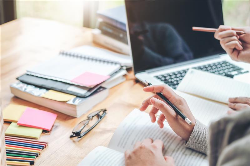 Student studying online with laptop and colourful sticky notes for homeschooling at Asra Hub